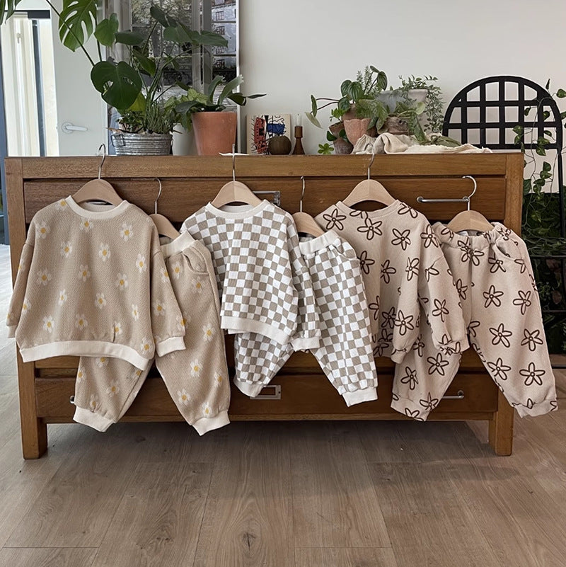 Sets in daisy, check and flower prints hanging on a dresser