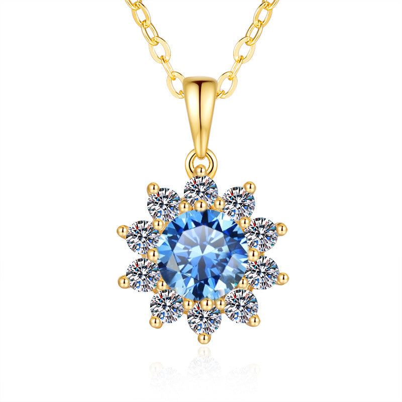 Goudkleurige zonnebloem hanger ketting goudkleurig met een blauwe middensteen en kleine witte accentstenen
