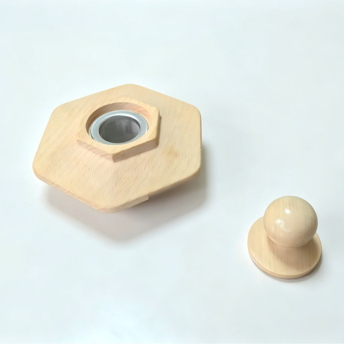 Hexagonal beech wood cocktail smoker top with metal ring, next to a separate round wooden knob