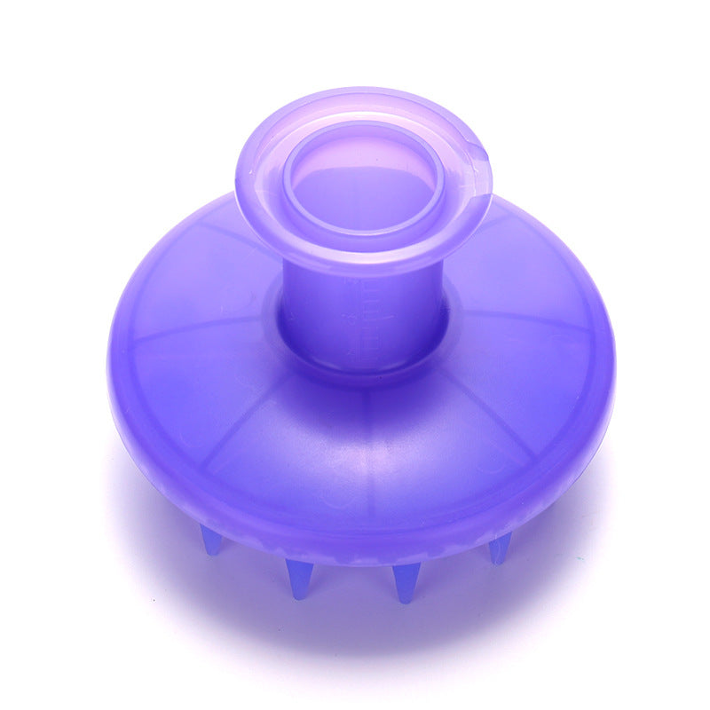 Lavender scalp brush from above, showing the wide disc shape of the tooth base