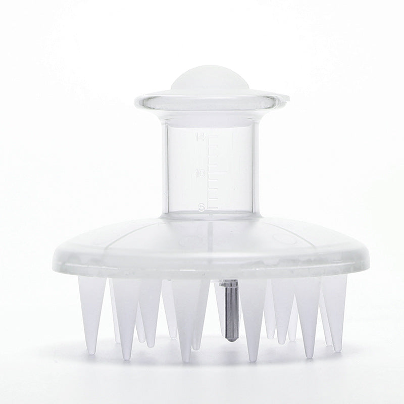 Clear plastic scalp brush with short conical bristles and a 14 ml reservoir on top