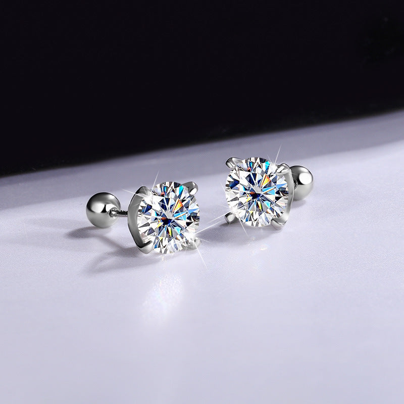 Pair of clear moissanite stud earrings on a dark and light background, front view