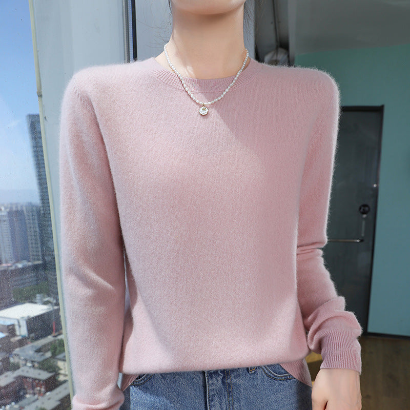 Pale pink mercerised wool crew-neck sweater on a model, worn with jeans