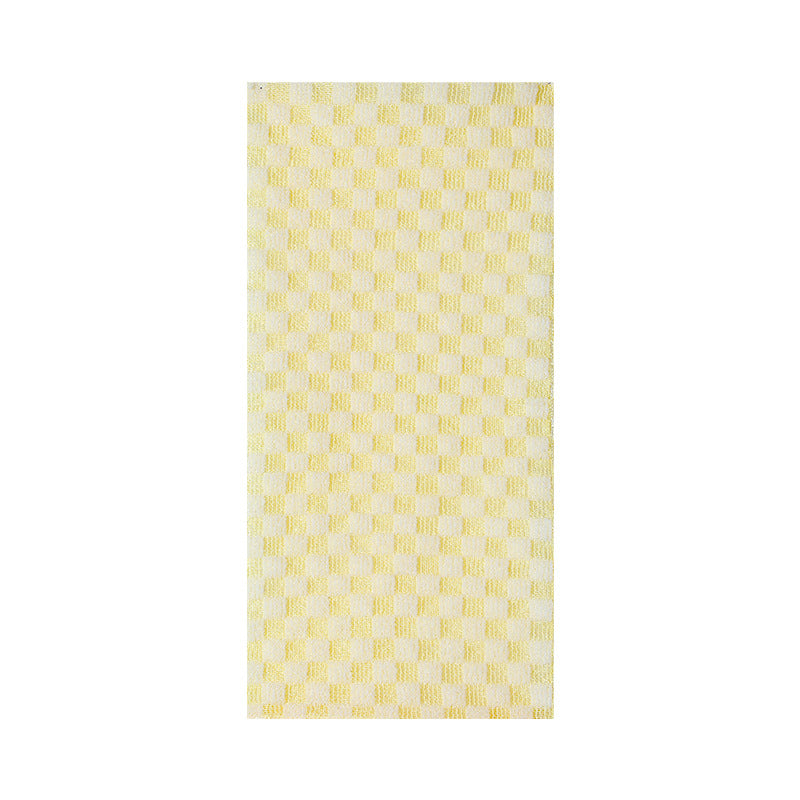 Pale yellow chequerboard bath towel laid flat, showing its full textured surface