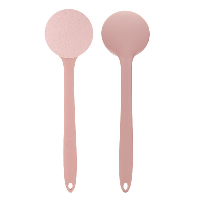 Front and back view of the light pink back lotion applicator, showing nubbed head and smooth domed back