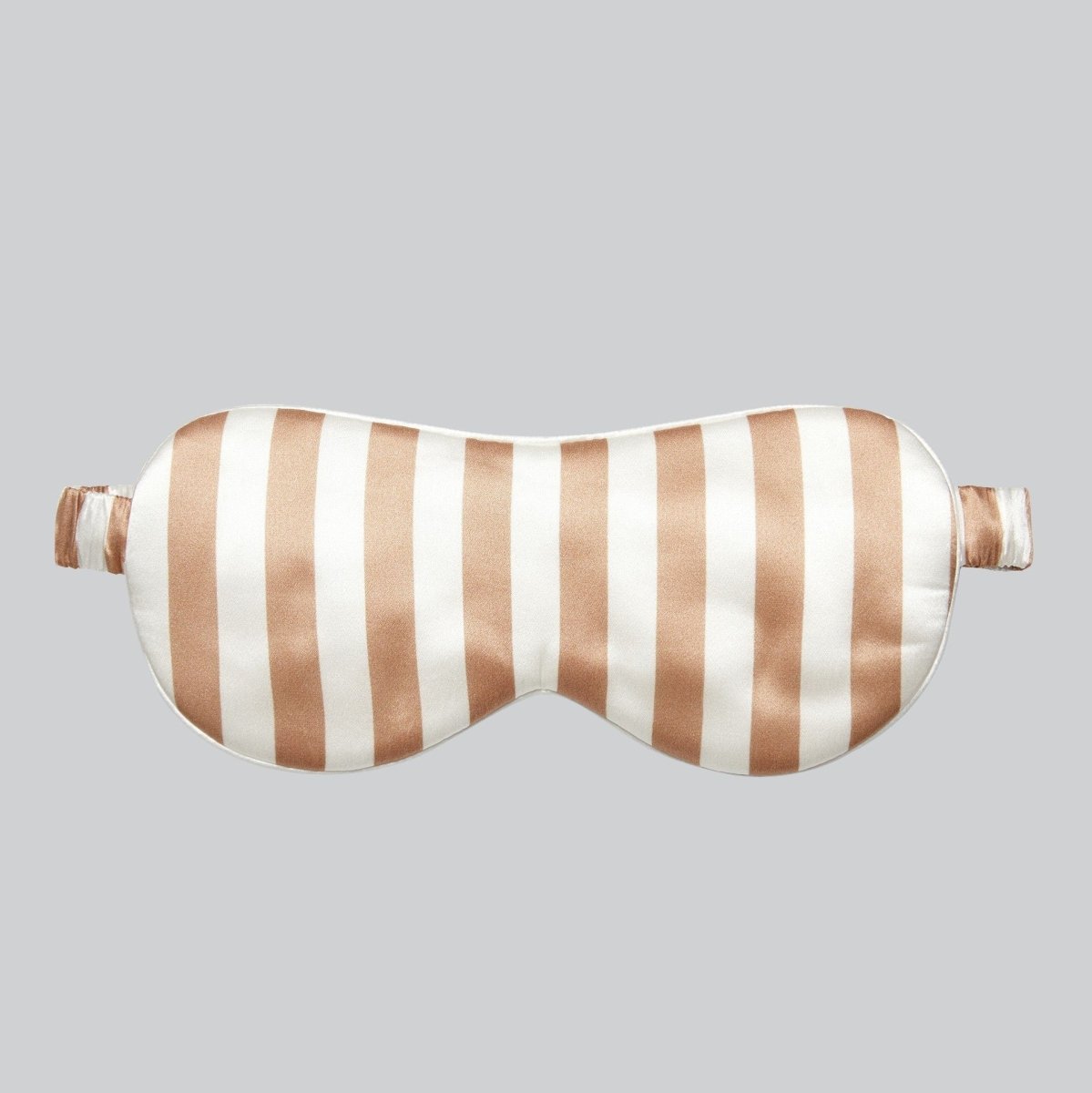 Coffee and white striped mulberry silk sleep mask, front view on a grey background