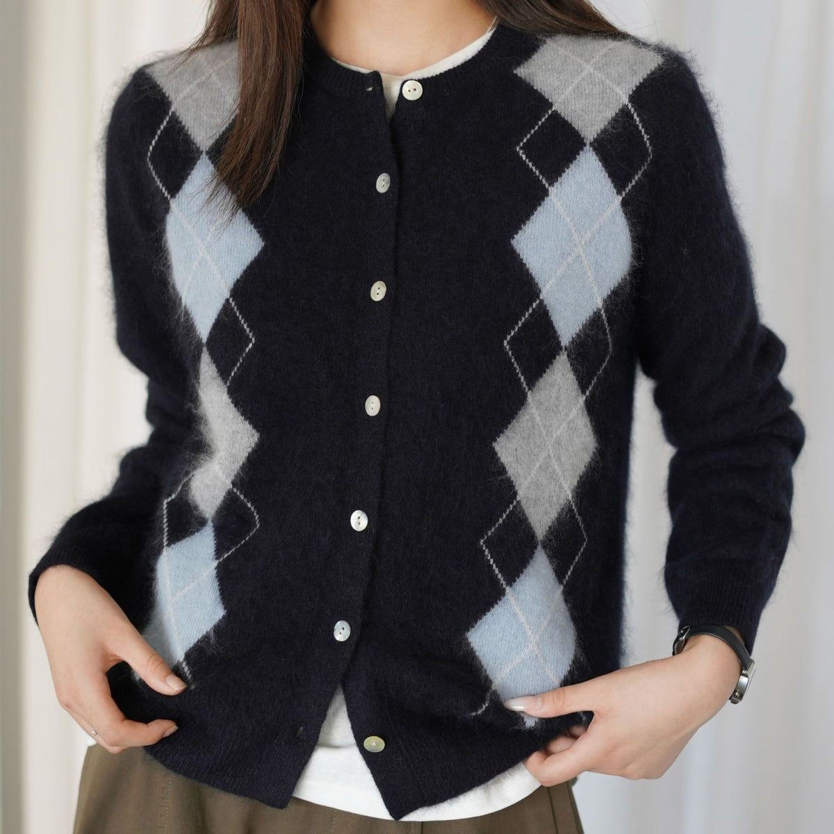 Navy argyle vest met lichtblauwe en grijze ruiten, close-up van knoopsluiting voor