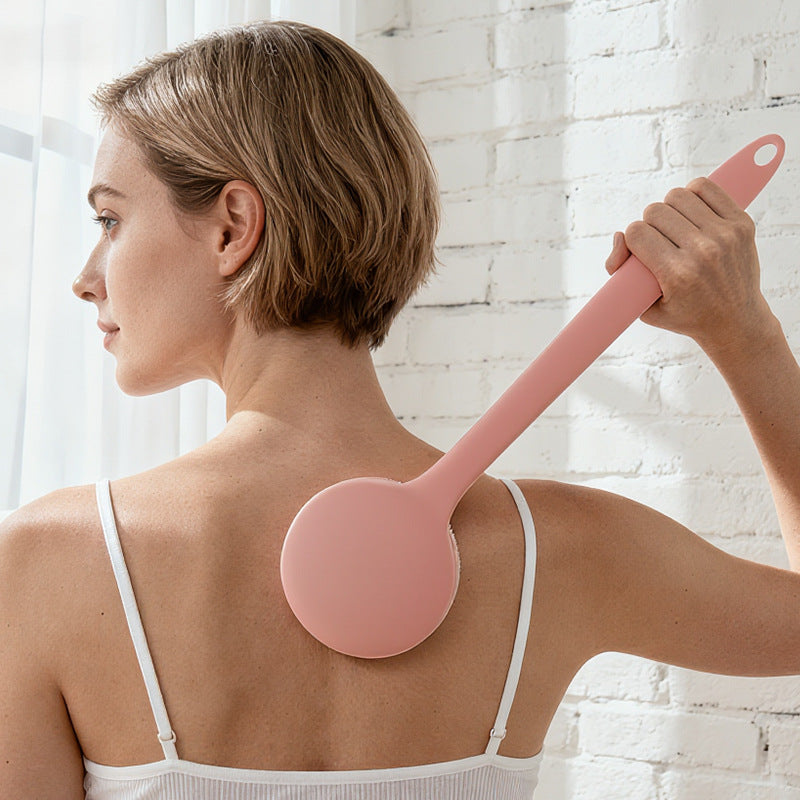 Person using the light pink long-handle back applicator on their upper back