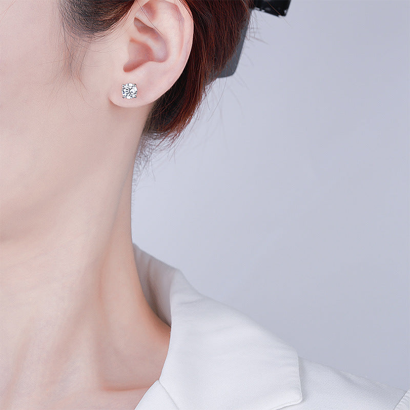 Clear moissanite stud earring worn on a model's earlobe, close-up