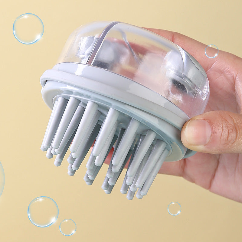 Grey shampoo brush held in a hand, showing the short rounded plastic teeth from below