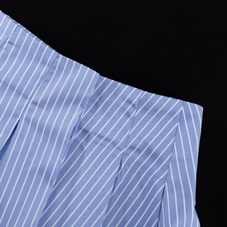 Blue and white striped pleated mini skirt laid flat, showing the waistband and pleats