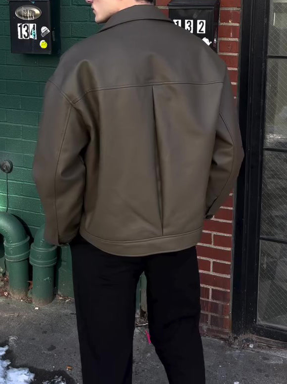 Back view of olive leather-look bomber jacket showing yoke and central pleat