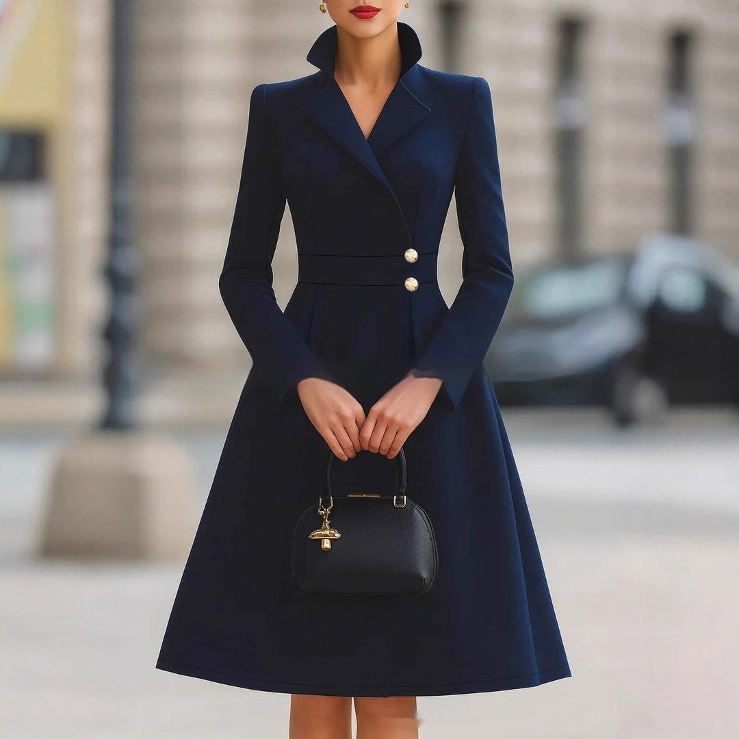 Navy double-breasted coat dress with gold-tone buttons, front view on model, A-line skirt, long sleeves, urban background