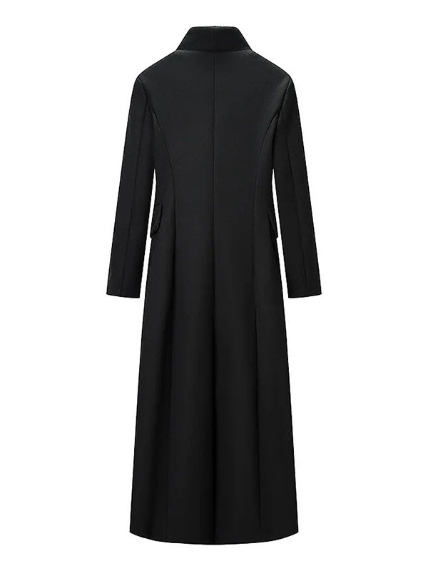 Back view of a long black tailored coat with high standing collar and vertical centre seam, flat lay
