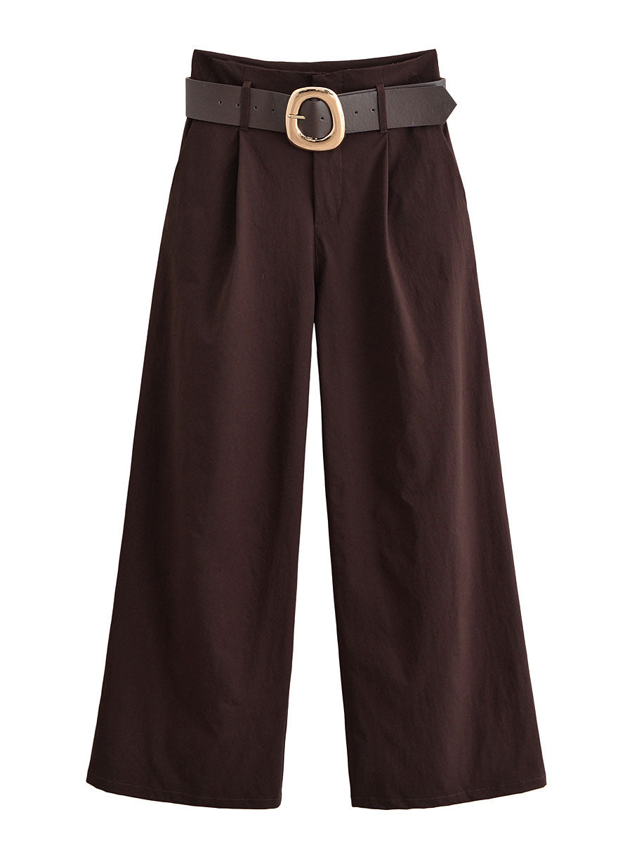 Front view of chocolate brown wide-leg trousers with a large gold-tone buckle on the belt
