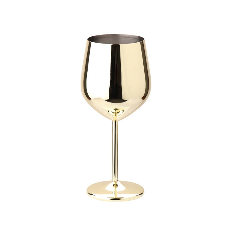 Gold stainless steel wine glass standing upright on white background, empty and reflective