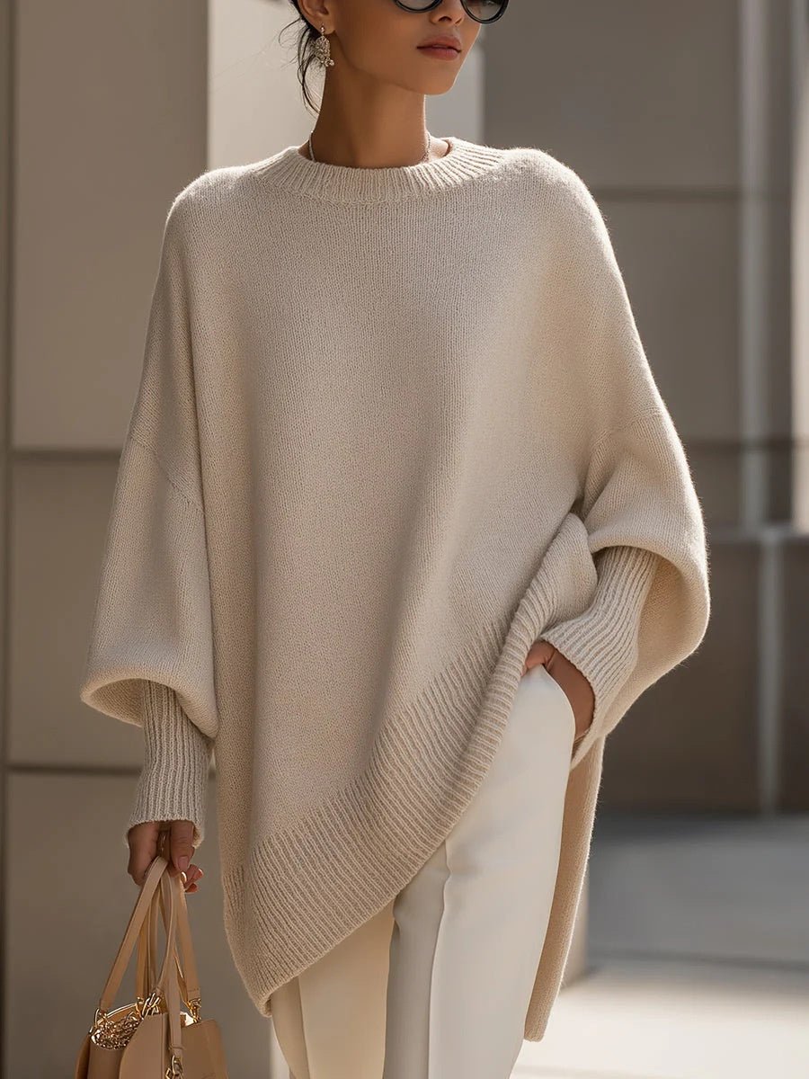 Cream batwing sweater with a wide ribbed border along the hem