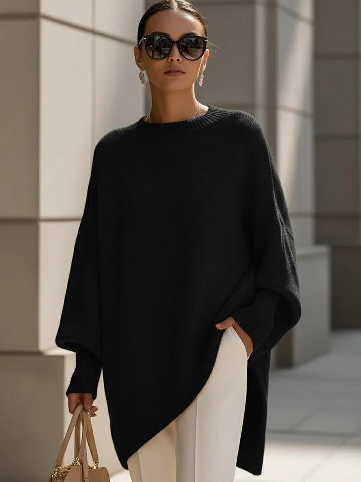 Black poncho-style sweater with round ribbed neck