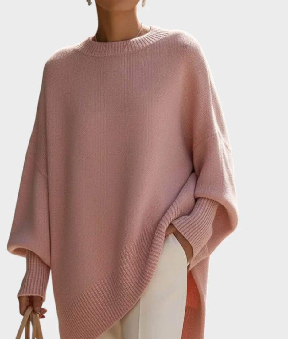 Pink poncho sweater on a light background