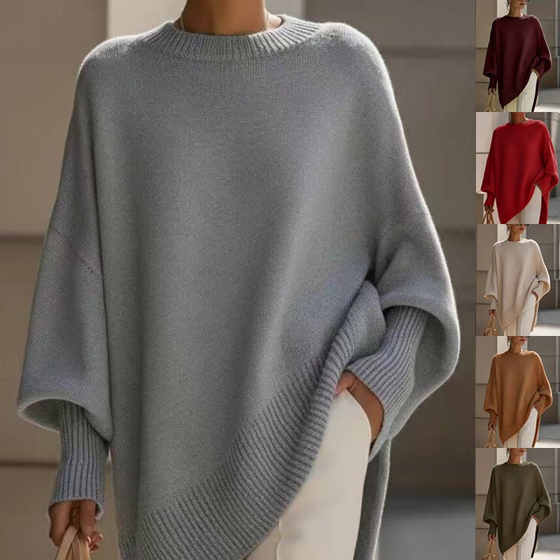 Light grey poncho sweater with slanted ribbed hem, with small insets of other colours