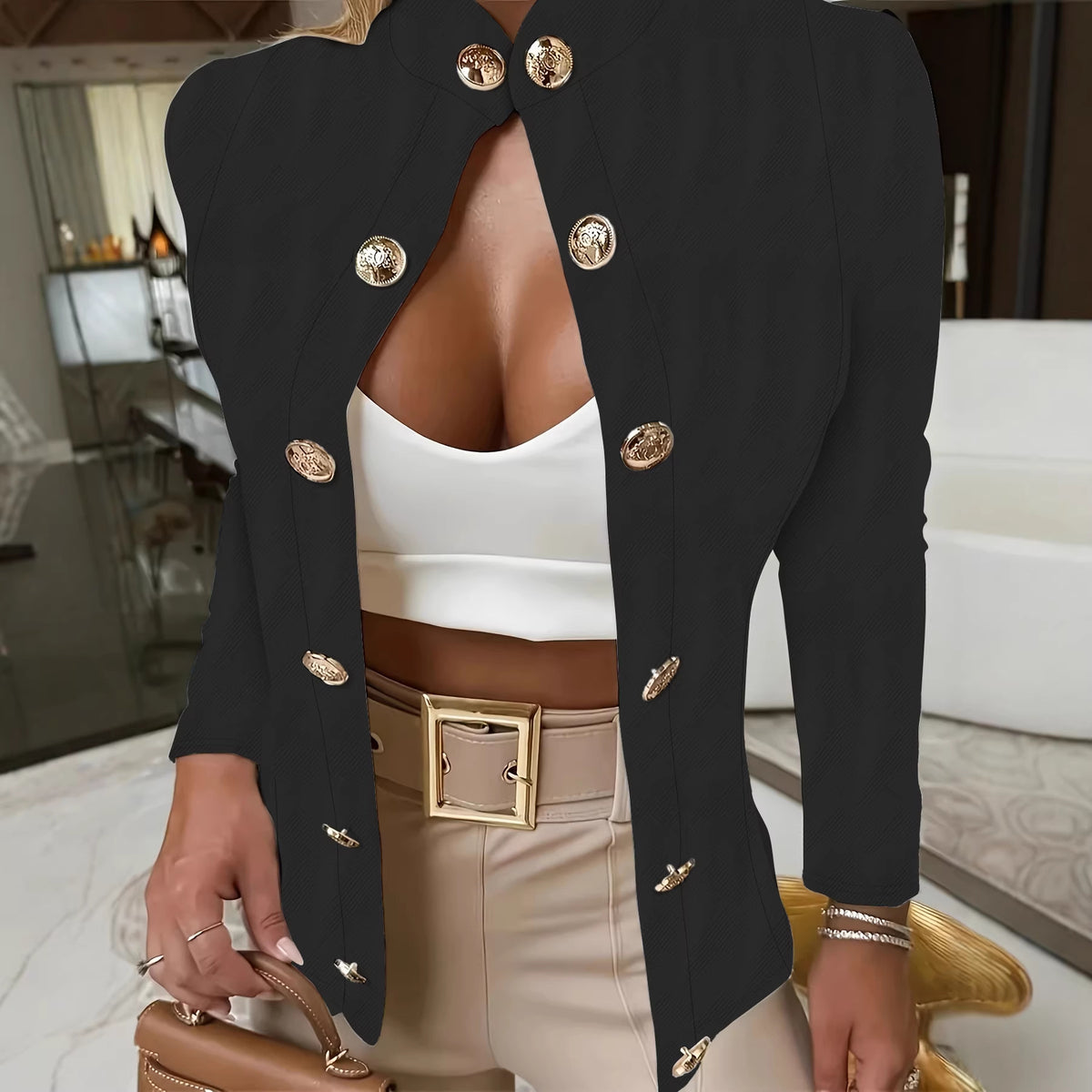 Black double-breasted stand-collar blazer with gold-tone buttons, worn over a white top and beige pants, front view on model