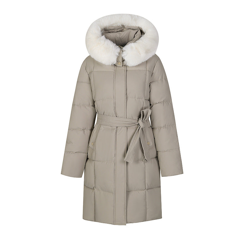 Mid-length padded coat in beige with faux-fur hood and tie belt, front view on white background
