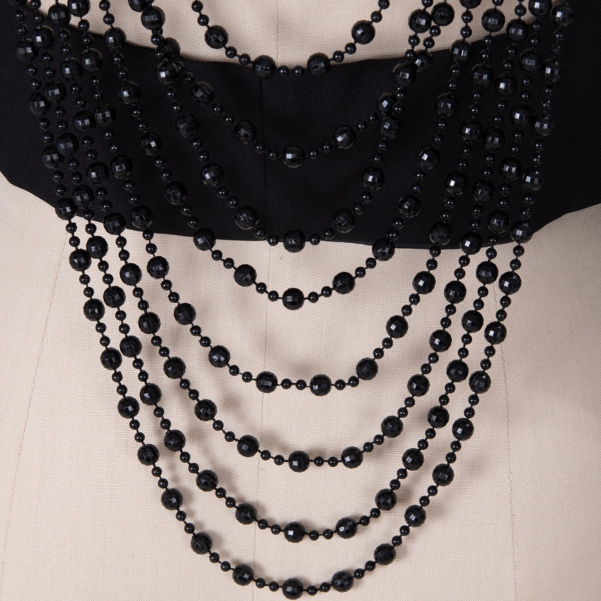 Detail of the black faceted beads hanging in curves
