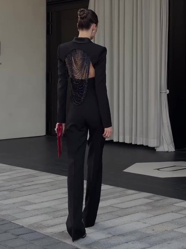Back view of the set on the street, red clutch in hand, beads hanging below the blazer hem