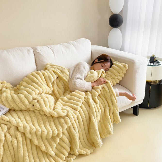 Custard ribbed throw in a soft yellow, draped over a sofa