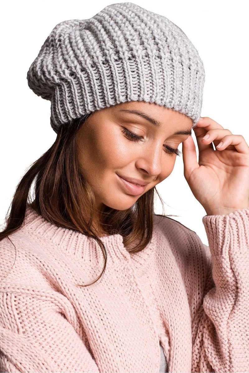 Knitted pink beanie hat with soft knit texture, perfect for winter warmth and casual style
