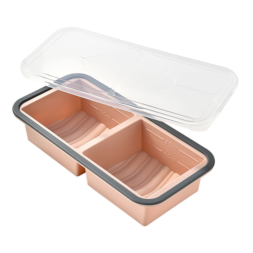 Two-compartment silicone freezer portion tray, peach colour, grey rim, clear lid, measuring marks, front view