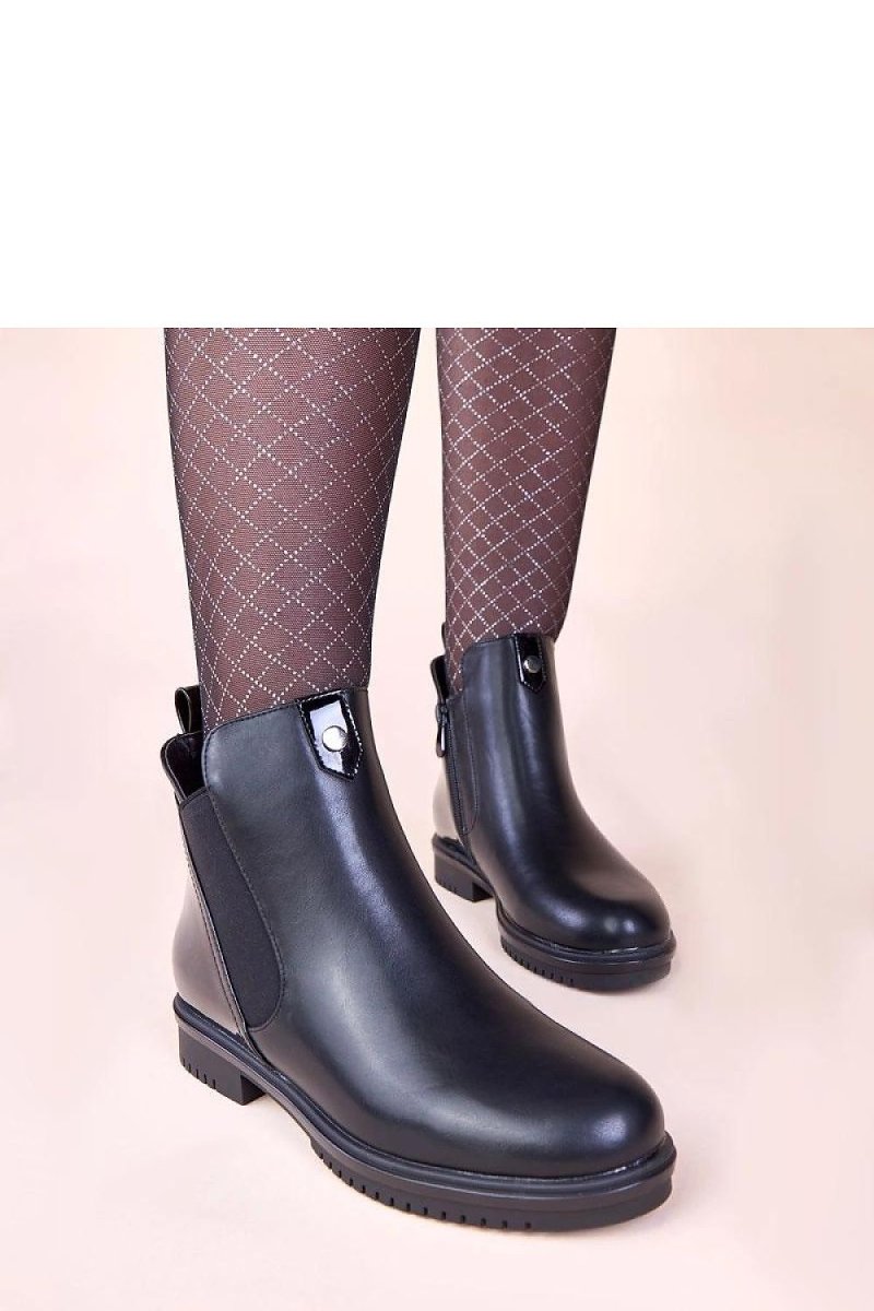 Solea ankle boots on a woman’s foot in black waterproof leather – perfect for rainy days
