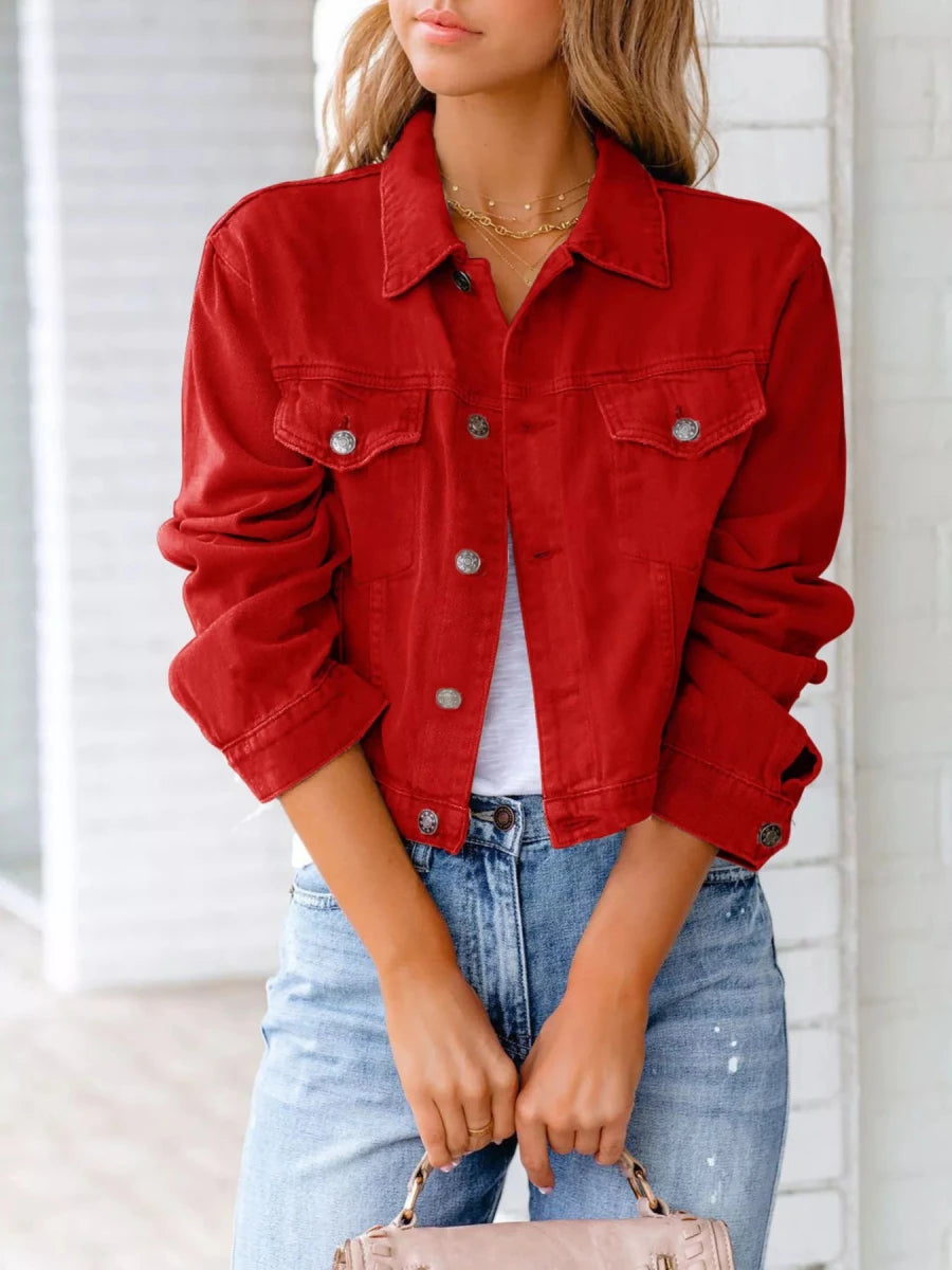 Button-up denim jacket with long sleeves, front buttons, and classic collar in blue wash