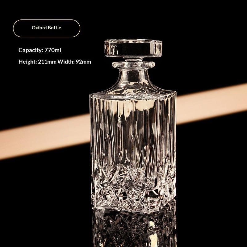 Oxford bottle, cut glass spirits decanter with stopper, front view, clear, vertical fluting, black background