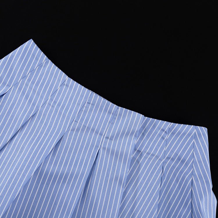 Blue and white striped pleated mini skirt laid flat, showing the pleats