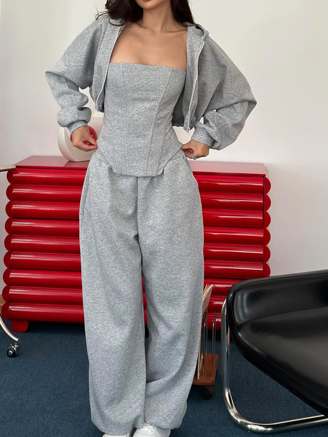 Grey corset top, cropped hoodie and wide-leg trousers set on model, front view, jacket open, square neckline visible
