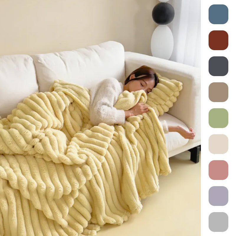 Custard ribbed faux fur throw on a white sofa, with swatches of the ten colours beside it