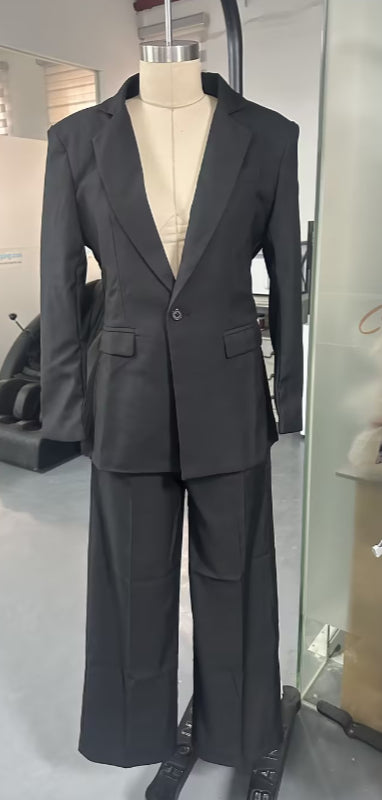 Front view of the black open-back blazer and wide-leg trouser suit on a mannequin