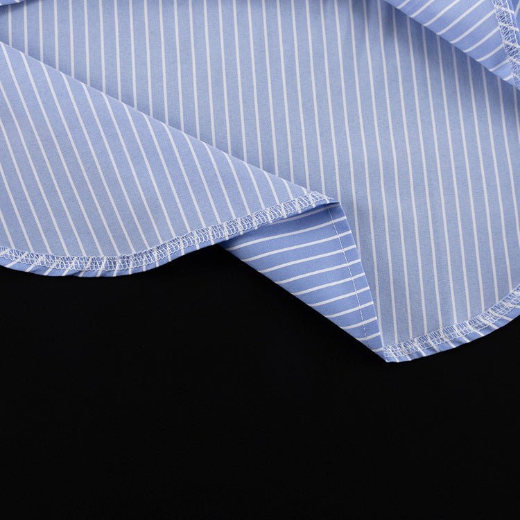 Detail of the blue and white striped shirt sleeve cuff and hem edge