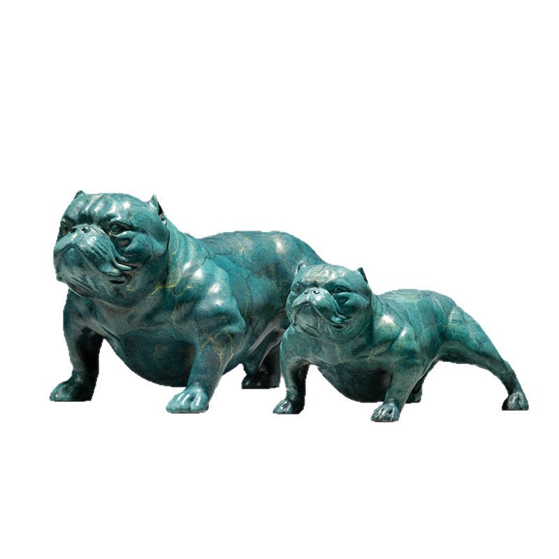 Cast metal bulldog sculpture with teal patina and gold-coloured veining, shown from the front, two figures in a crouching
