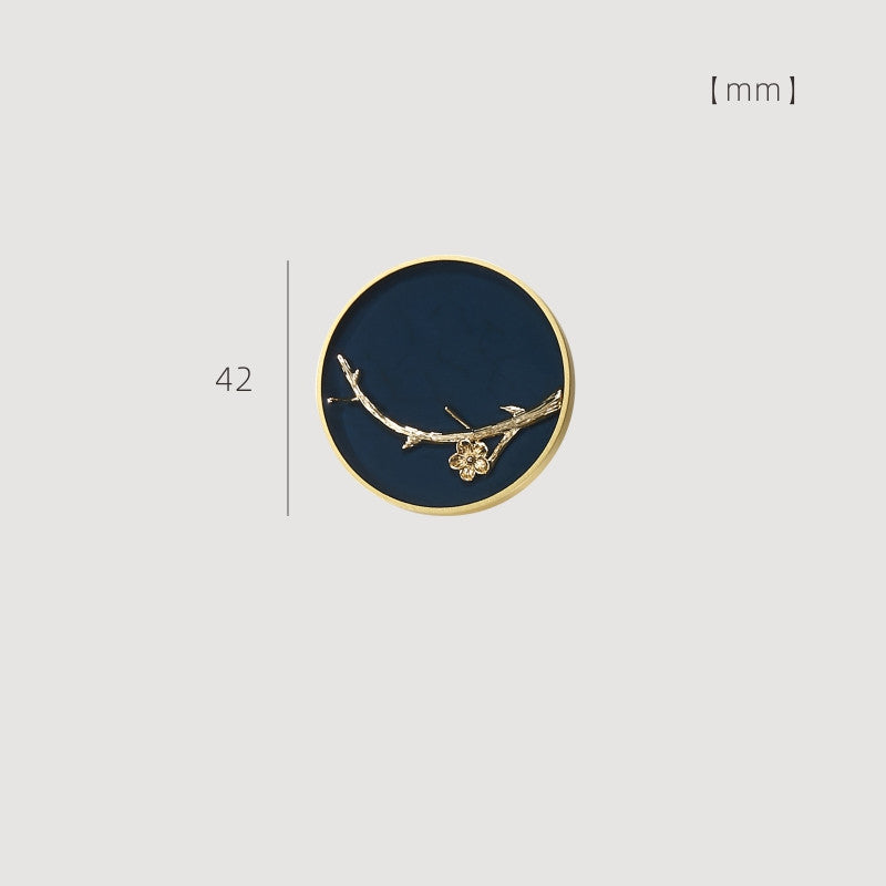 42 mm enamelled drawer knob with gold-tone rim and blue background featuring a wintersweet branch design
