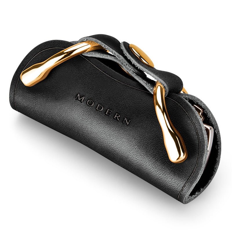 Black key organiser with gold-tone clips seen at an angle