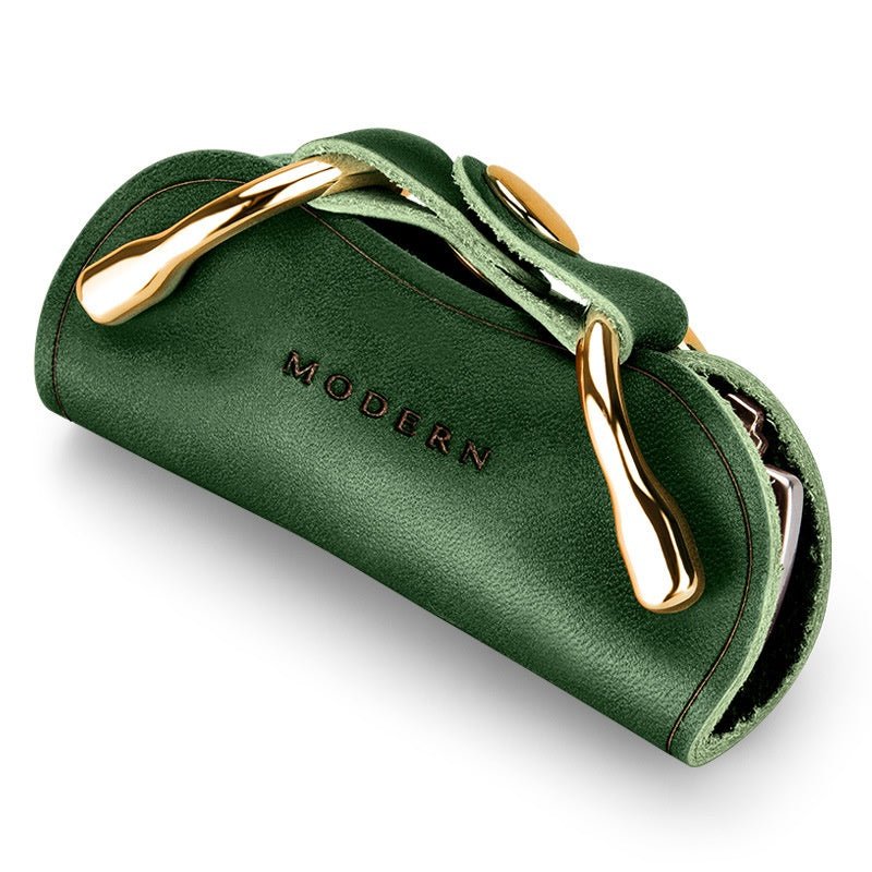 Green key organiser with gold-tone clips seen at an angle