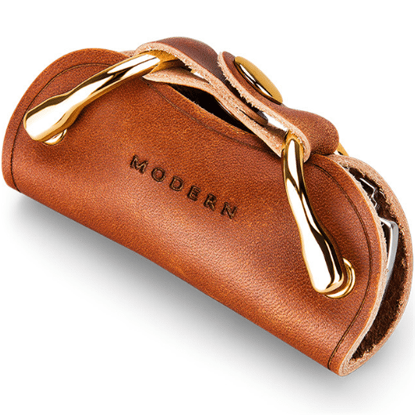 Brown key organiser seen at an angle, with raw cut edges and the snap on the flap