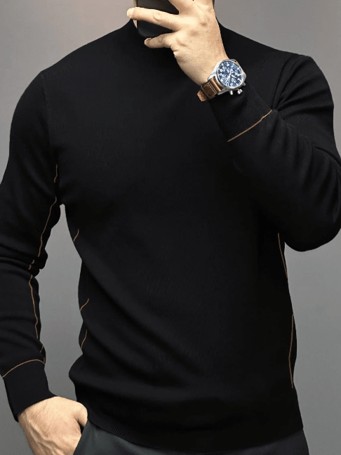 Man in a black long-sleeve sweater with light brown contrast stitching on the sleeve and side seams