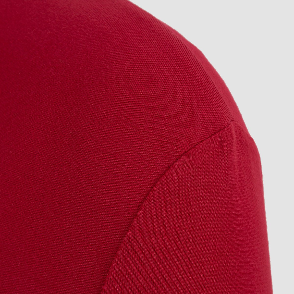 Close-up of the shoulder seam on the smooth red fabric