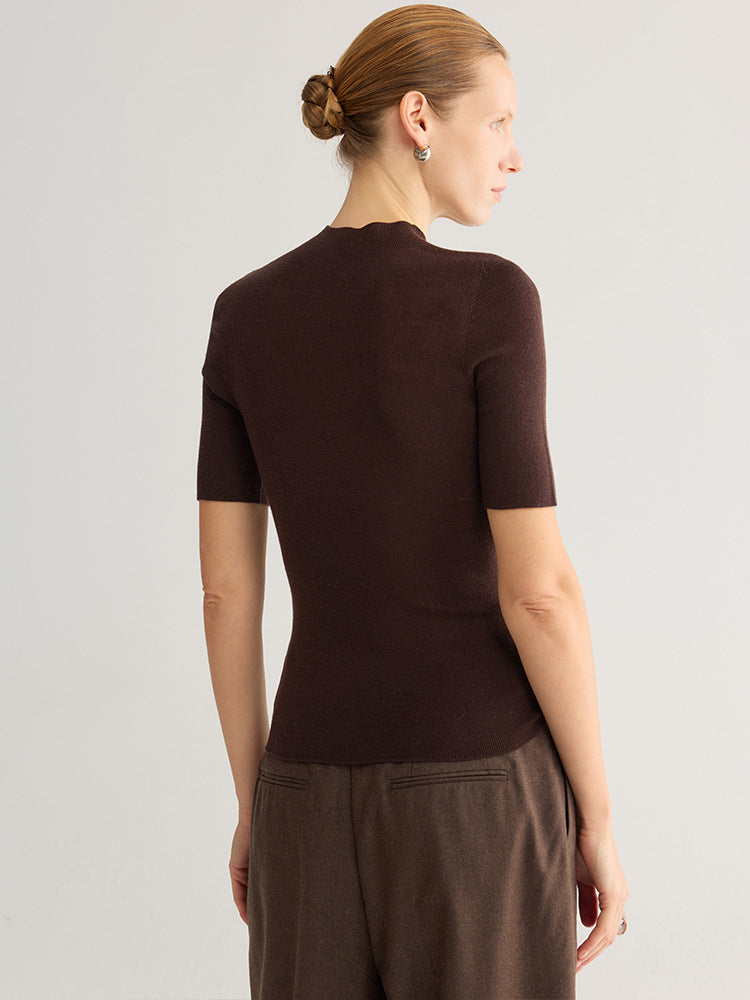 Seamless half-turtleneck knit top, short sleeve, dark coffee, back view on model, plain background