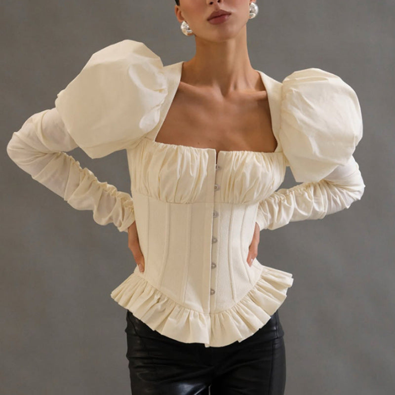 White square-neck corset top with puff sleeves and peplum hem, front view on model against gray background