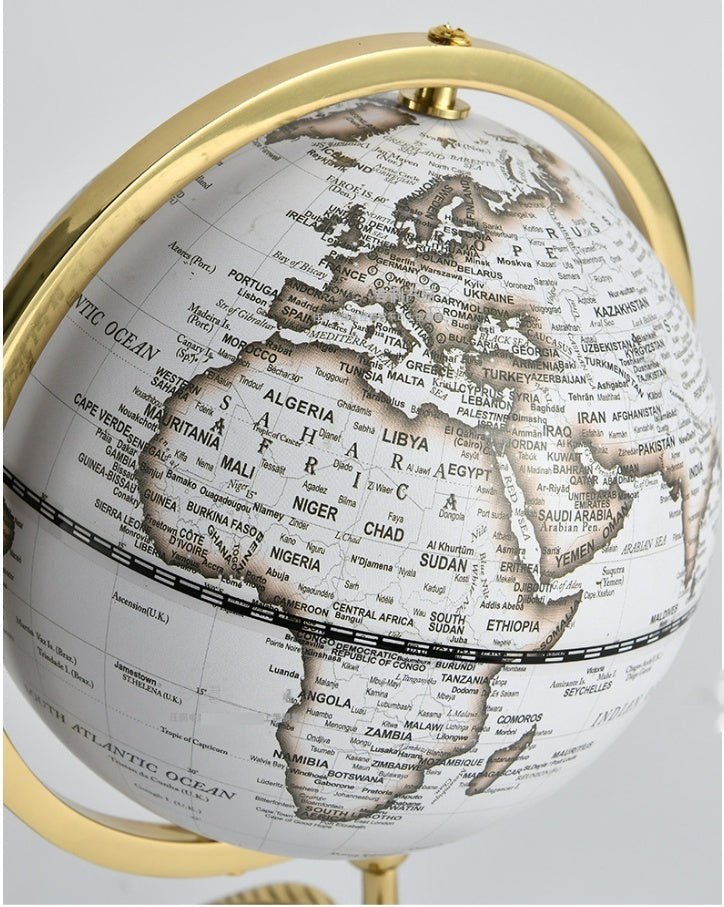 Desk globe with white antique-style map, gold-coloured ring and stem, showing Africa and Europe, on black square base