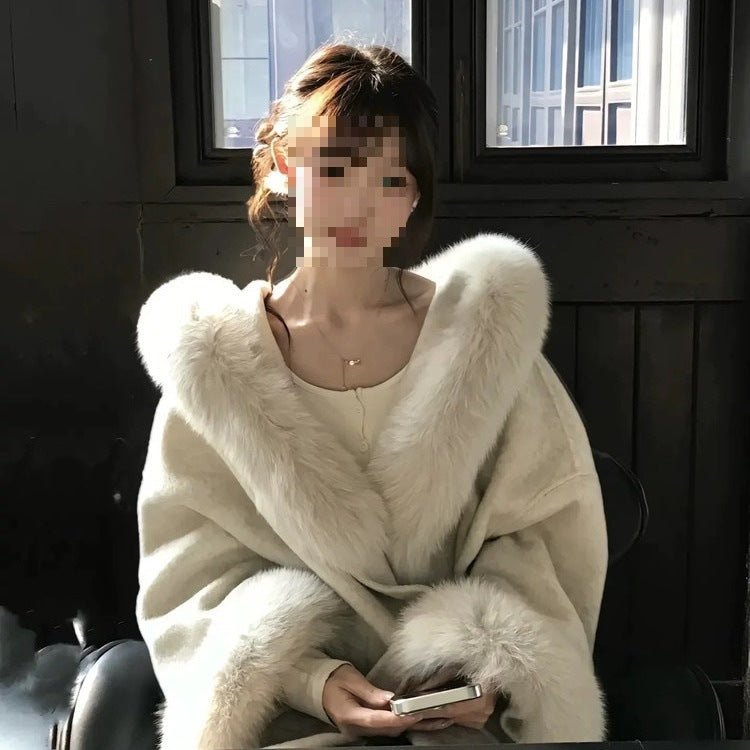 Close view of the full faux fur collar and wide fur cuffs on the cream coat